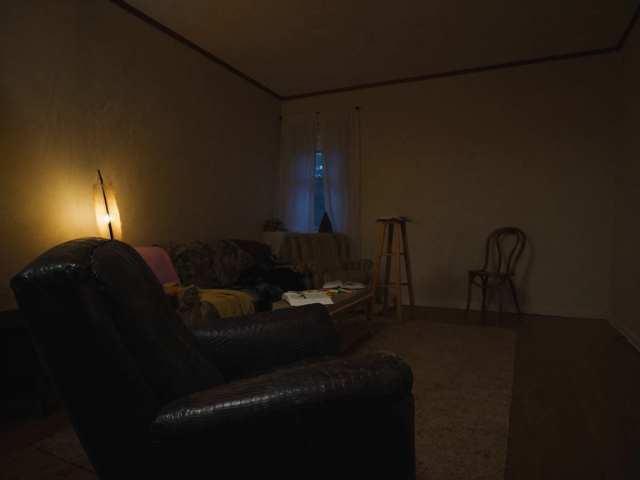 A high school youth room with a sofa and armchairs facing a stool and music stand for a guest speaker